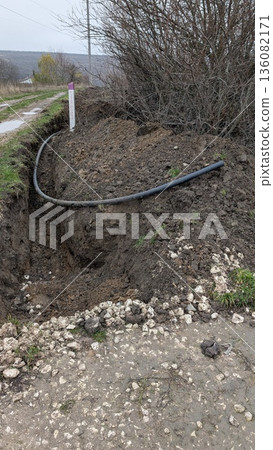 The process of laying plastic pipes underground to provide the village with water The process of laying plastic pipes underground to provide the village with water 136082171
