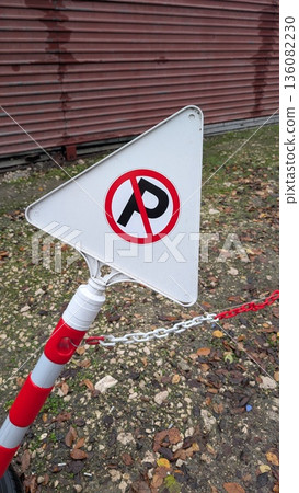 Gravelly textured wall behind makeshift parking restriction sign Gravelly textured wall behind makeshift parking restriction sign 136082230
