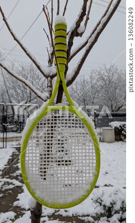 Chilly backyard with tennis racket and frosted surroundings Chilly backyard with tennis racket and frosted surroundings 136082249