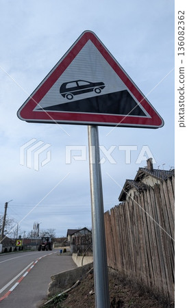 Steep descent warning sign alerting commuter drivers on suburban street Steep descent warning sign alerting commuter drivers on suburban street 136082362
