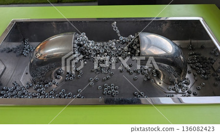 Metallic Black Display, Shiny Ferrofluid Featuring Domes And Iron Beads In Scientific Arrangement Metallic Black Display, Shiny Ferrofluid Featuring Domes And Iron Beads In Scientific Arrangement 136082423