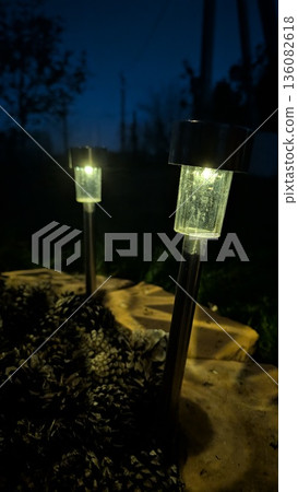 ECO Friendly Outdoor Lighting Highlighting Serene Atmosphere With LED Stake Lamps Near Rocks And Bushes ECO Friendly Outdoor Lighting Highlighting Serene Atmosphere With LED Stake Lamps Near Rocks And Bushes 136082618