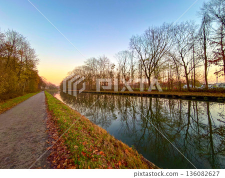 Rijkevorsel, Antwerpse Kempen, Belgium, Scenic riverside route with glowing sky and tranquil 136082627