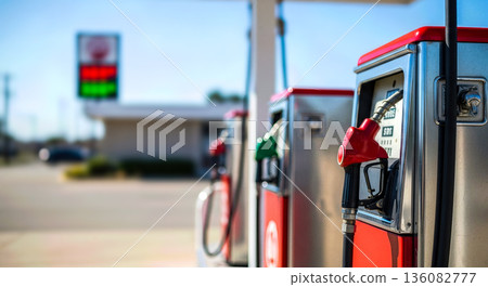 Row of classic vintage red gas pumps with analog meters at sunny day for retro transportation and americana road trip nostalgia concept history Row of classic vintage red gas pumps with analog meters at sunny day for retro transportation and americana road trip nostalgia concept history 136082777