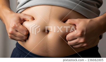 Overweight man pinching belly fat with both hands close up obesity weight loss concept diet health care problem body shape 136082805
