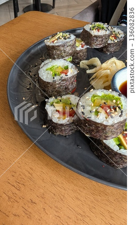 Sushi Rolls Beautifully Arranged on an Elegant Black Plate, Making Every Bite Gourmet Sushi Rolls Beautifully Arranged on an Elegant Black Plate, Making Every Bite Gourmet 136082836