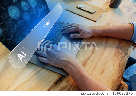 Person typing on a laptop at a wooden table while working with artificial intelligence 136083279