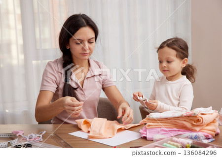 Mother and little daughter bonding, learning craft skills, and creating handmade items Mother and little daughter bonding, learning craft skills, and creating handmade items 136084296