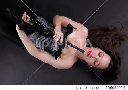 Girl holding Rifle on black background 136084914