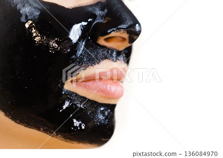 Woman with black peel off mask on face Woman with black peel off mask on face 136084970