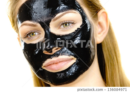 Girl black carbo peel off mask on face Girl black carbo peel off mask on face 136084971