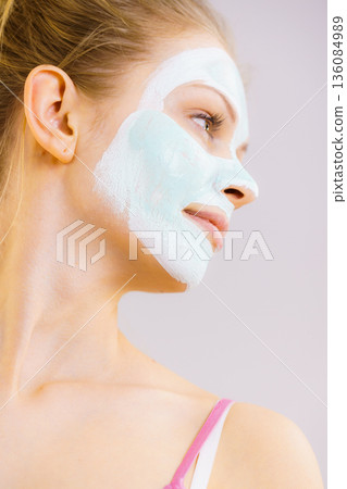 Girl with white green mud mask on face Girl with white green mud mask on face 136084989