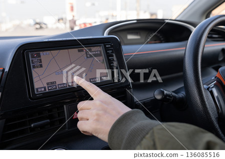 A person driving a car 136085516