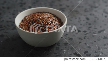flaxseed in white bowl on terrazzo countertop with copy space flaxseed in white bowl on terrazzo countertop with copy space 136086014