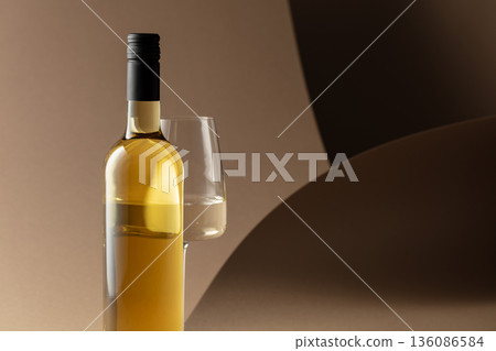 Bottle and glass of white wine. 136086584