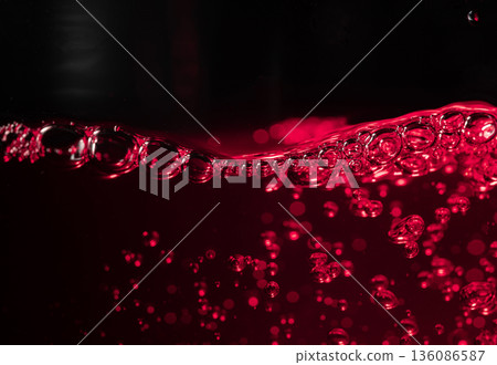 Red wine on a black background, abstract splashing. Red wine on a black background, abstract splashing. 136086587