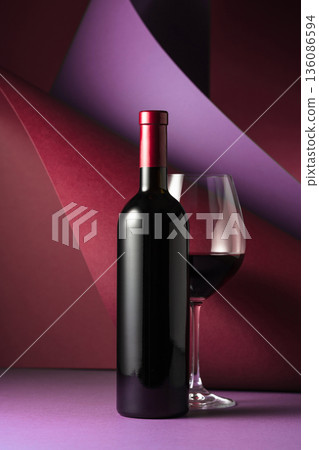 Bottle and glass of red wine. Bottle and glass of red wine. 136086594