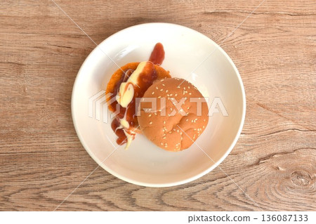 fried spicy mashed chicken hamburger dressing mayonnaise and ketchup sauce on plate fried spicy mashed chicken hamburger dressing mayonnaise and ketchup sauce on plate 136087133