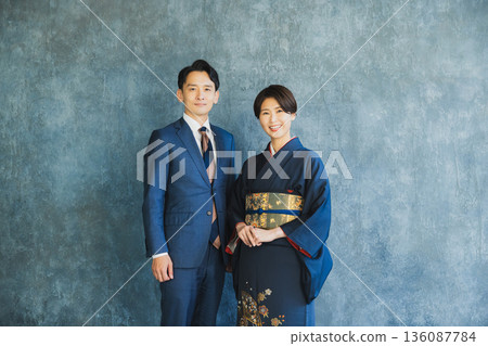 A man in a suit and a woman in a kimono A man in a suit and a woman in a kimono 136087784