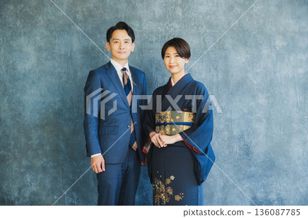 A man in a suit and a woman in a kimono A man in a suit and a woman in a kimono 136087785