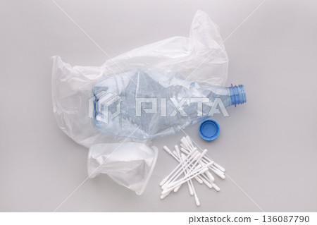 Plastic waste showing single-use pollution on a gray background 136087790