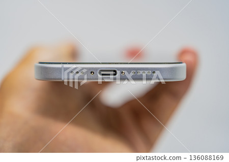 Smartphone in hand on white background Smartphone in hand on white background 136088169
