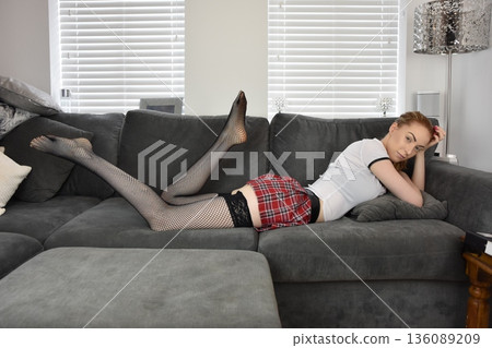 Pretty, redhead model dressed as a fantasy schoolgirl, at home on her own at her parents' house Pretty, redhead model dressed as a fantasy schoolgirl, at home on her own at her parents' house 136089209