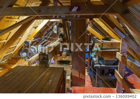 Old windmill interior showing traditional grain milling machinery Old windmill interior showing traditional grain milling machinery 136089402