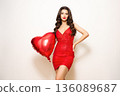 Young woman with heart shape air balloon 136089687
