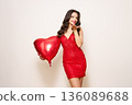 Young woman with heart shape air balloon 136089688