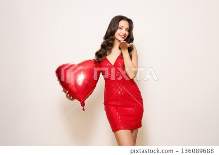 Young woman with heart shape air balloon Young woman with heart shape air balloon 136089688