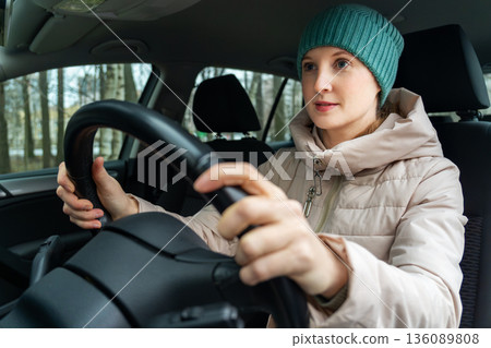 A woman is sitting in a car A woman is sitting in a car 136089808