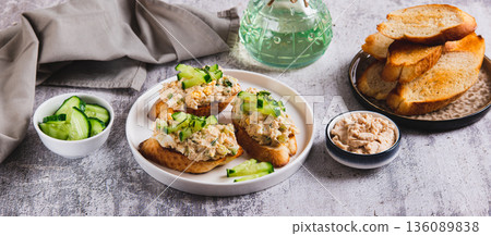Delicious sandwiches with cod liver salad, egg and cucumber on a plate on the table web banner Delicious sandwiches with cod liver salad, egg and cucumber on a plate on the table web banner 136089838