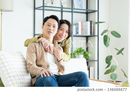 A middle-aged couple having a good time in the living room A middle-aged couple having a good time in the living room 136089877