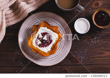 Sweet toasts with ricotta, berry jam and pastila on a plate on the table top view 136090521