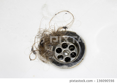 Unblocking brown hair from sink hole drain close up unhygenic gross job Unblocking brown hair from sink hole drain close up unhygenic gross job 136090598