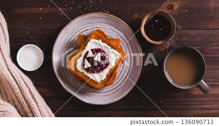 Delicious toasts with cream cheese, jam, paste and coconut flakes on a plate top view web banner 136090711