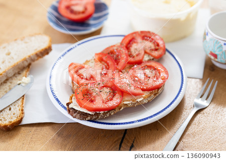 two bruschettas with tomato slices on a plate two bruschettas with tomato slices on a plate 136090943
