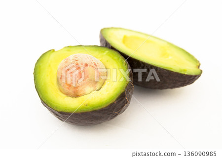 halved avocado with bone on white background halved avocado with bone on white background 136090985