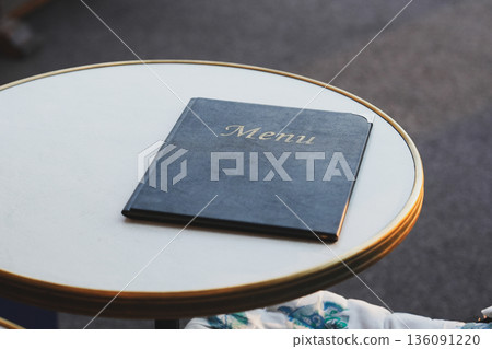 The black leather menu book on the table. The black leather menu book on the table. 136091220