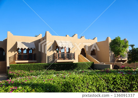 A luxury hotel in an Arabian resort with a green, lush garden and large grounds 136091337
