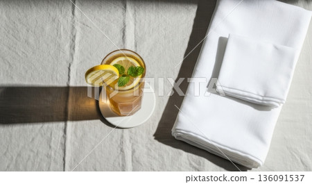 Minimalist Iced Tea with Lemon and Mint on Linen Tablecloth 136091537