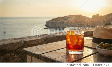Refreshing Negroni Cocktail Held Over Mediterranean Sea View Refreshing Negroni Cocktail Held Over Mediterranean Sea View 136091574