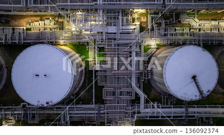 Aerial view Oil and Gas refinery plant at night, Global business energy logistic transportation, Oil and gas refinery petrochemical industrial, Petrochemical refinery industrial energy supply chain. 136092374