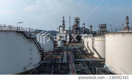 Aerial view oil and gas petrochemical tank with oil and gas refinery plant background, Global business power and energy petrochemical barrel, Petrochemical refinery industrial energy supply chain. Aerial view oil and gas petrochemical tank with oil and gas refinery plant background, Global business power and energy petrochemical barrel, Petrochemical refinery industrial energy supply chain. 136092381