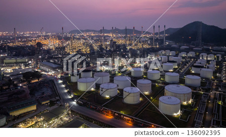 Aerial view Oil and Gas refinery plant at night, Global business energy logistic transportation, Oil and gas refinery petrochemical industrial, Petrochemical refinery industrial energy supply chain. 136092395
