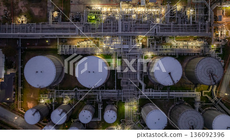 Aerial view Oil and Gas refinery plant at night, Global business energy logistic transportation, Oil and gas refinery petrochemical industrial, Petrochemical refinery industrial energy supply chain. Aerial view Oil and Gas refinery plant at night, Global business energy logistic transportation, Oil and gas refinery petrochemical industrial, Petrochemical refinery industrial energy supply chain. 136092396