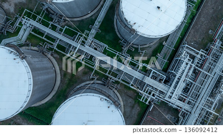 Aerial view oil and gas refinery petrochemical storage tank and pipeline steel, Oil and gas transportation system pipeline steel at oil and gas refinery industry chemical plant, Pipeline oil and gas. Aerial view oil and gas refinery petrochemical storage tank and pipeline steel, Oil and gas transportation system pipeline steel at oil and gas refinery industry chemical plant, Pipeline oil and gas. 136092412