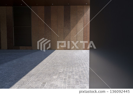 A minimalist composition of light and shadows falling on the wall and floor of a modern building A minimalist composition of light and shadows falling on the wall and floor of a modern building 136092445