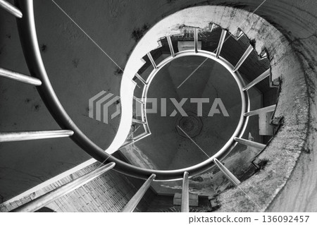 Monochrome representation of a spiral staircase looking up at a circular structure Monochrome representation of a spiral staircase looking up at a circular structure 136092457